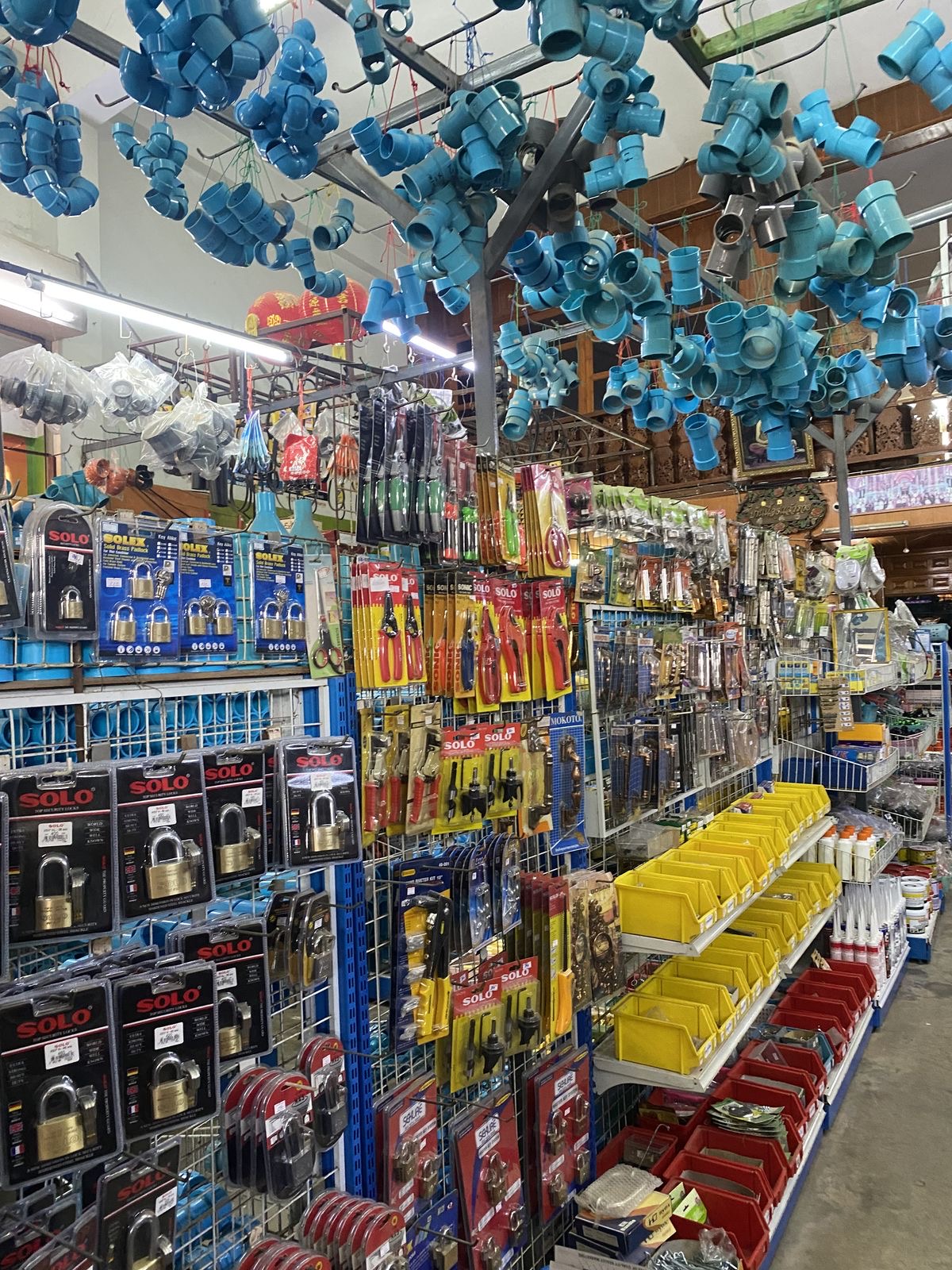 Hardware store shelves stocked with building supplies, tools and plumbing fittings