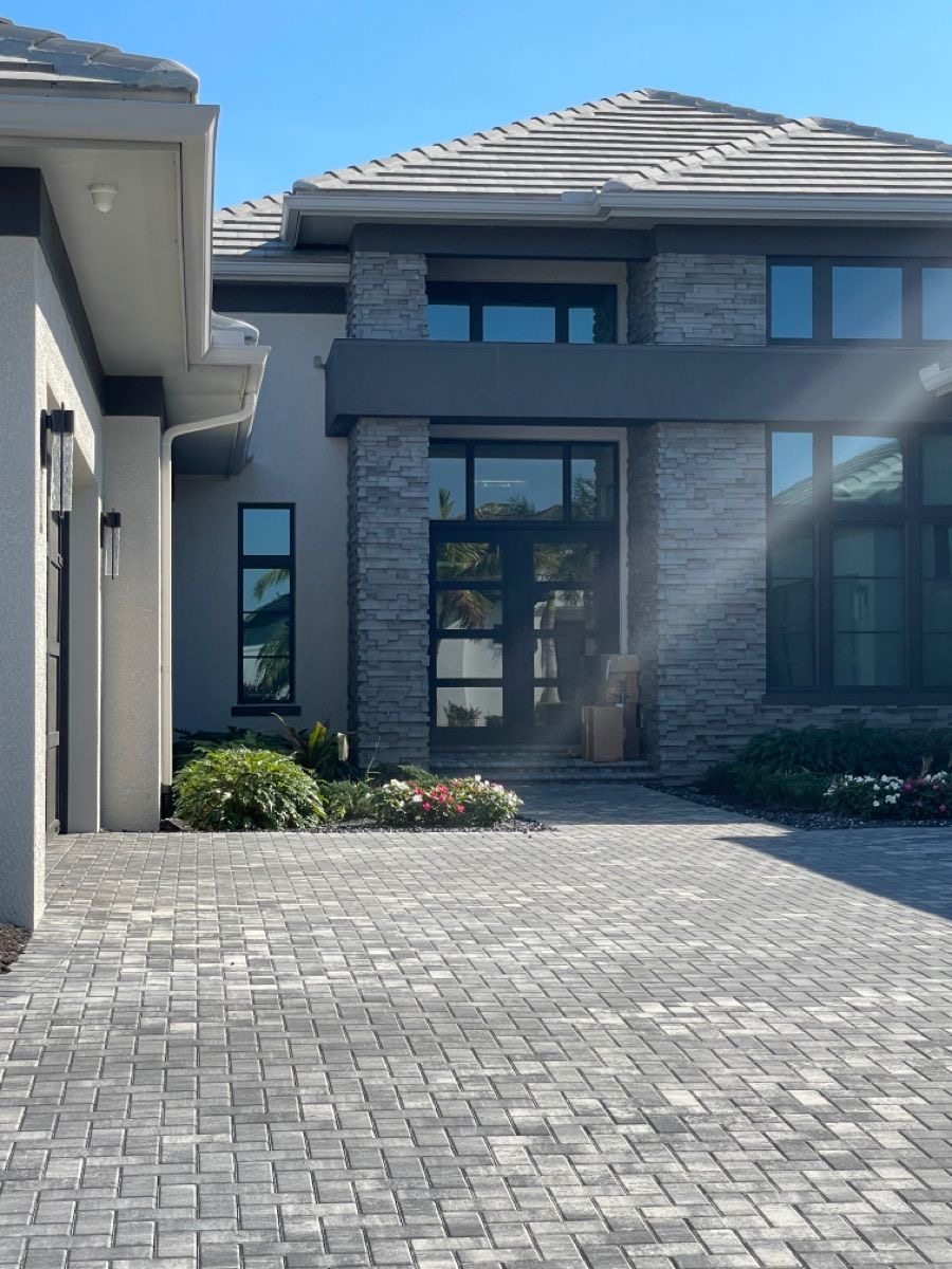 Residential entrance framed by stone pillars and glass doors