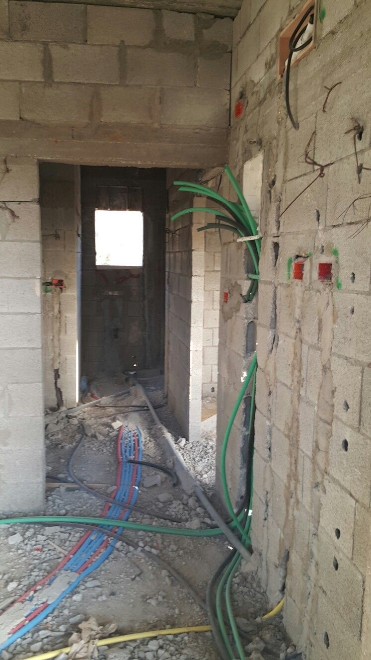 Electrical and plumbing services installed within masonry walls